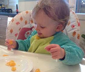picture of a toddler spitting out orange pieces