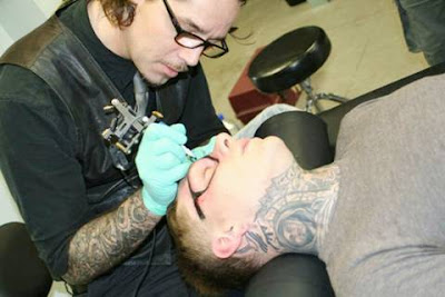 A Guy Gets His Face Tattoed