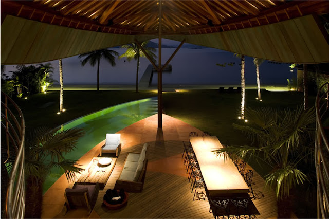 Picture of living and dining area by the pool as seen from the upper floor