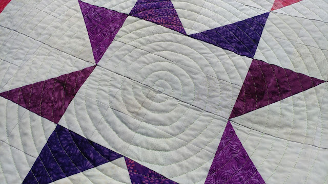 Modern Jacob's Ladder quilt using Island Batik fabrics and spiral walking foot quilting