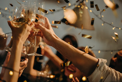 People celebrating and toasting with wine glasses