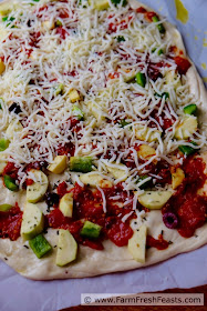 This pizza is a vegetarian's Late Summer Dream. Squash, peppers, olives and slow-roasted tomatoes covered with cheese.