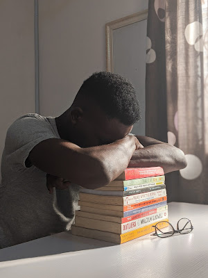 A man taking a nap on books