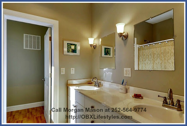 The master bathroom of this 4 bedroom equestrian property for sale on the Outer Banks NC also has a double sink vanity and a large bathtub. 