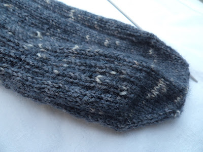 A single, half knitted sock 