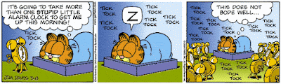 Garfield waking up from al lot of clocks ticking