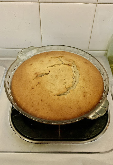 Cinnamon cake baked in a round glass pie dish