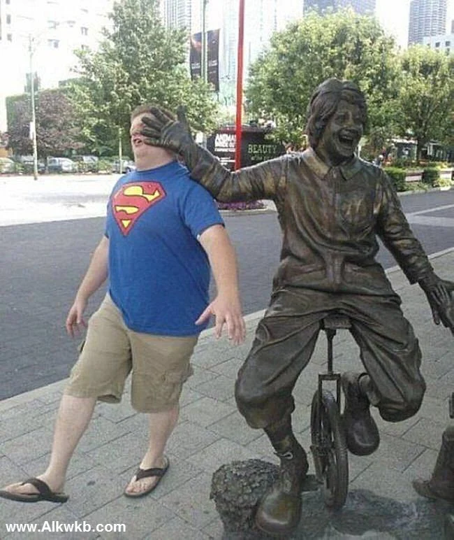 People Posing With Statues