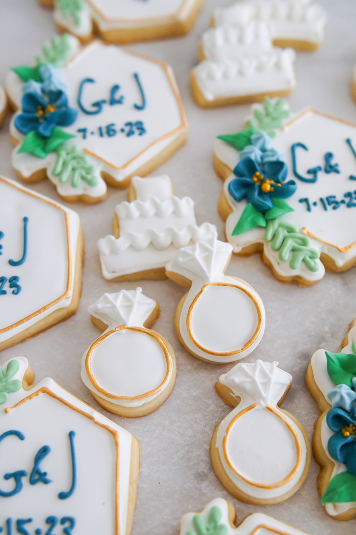 set of navy and gold themed decorated wedding cookies
