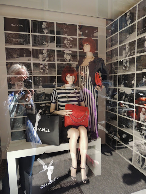 Chanel window display with red bob wigs and black and white photos