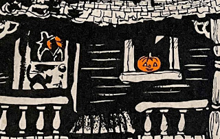 Witch, black cat, and JOL at front door porch of a 1950's vintage Halloween haunted house by Hallmark.