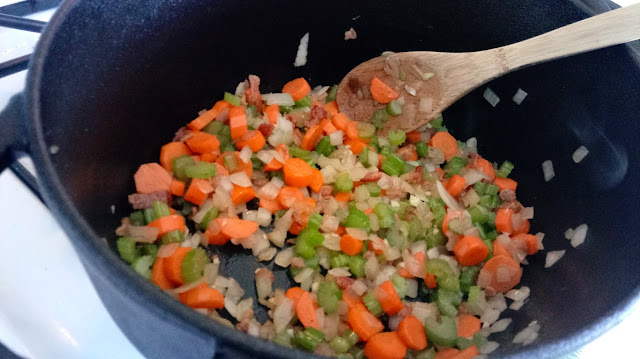 a large cast iron dutch oven with veggies cooking in it