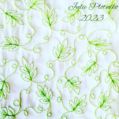 Green stitching of little leaves on a white background