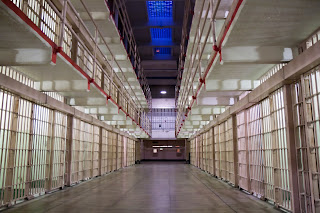 Picture of the inside of a large, state prison.