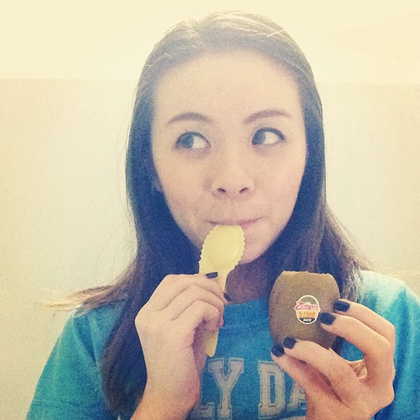 Girl eating kiwi