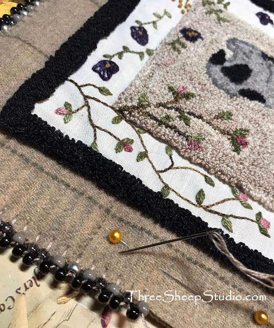 'Spring Lamb' punch needle embroidery by Rose Clay. Punch Needle design uses Valdani variegated Perle, Rustic Wool Moire Thread and is embellished with Hand Embroidery