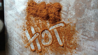 the word "hot" written in brown powder 