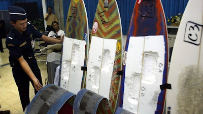 An Indonesian customs officer inspects surfing boards used by Brazil's citizen Rodrigo Gularte to smuggle six kilograms of cocaine. (AAP)