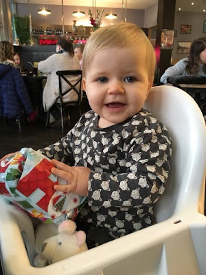 Image showing a baby girl excitedly opening a Christmas present