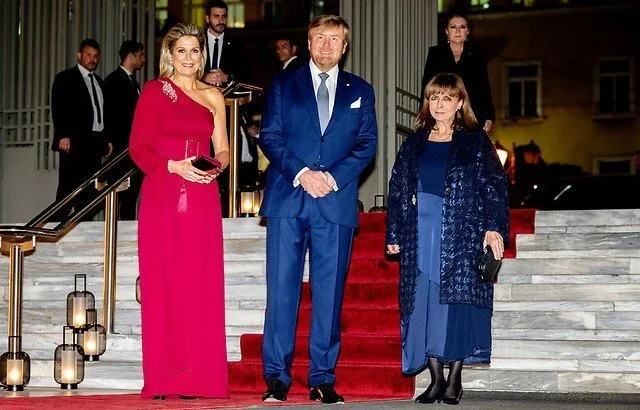 Queen Maxima wore a one-shoulder red gown by Claes Iversen. President of Greece Katerina Sakellaropoulou and Pavlos Kotsonis