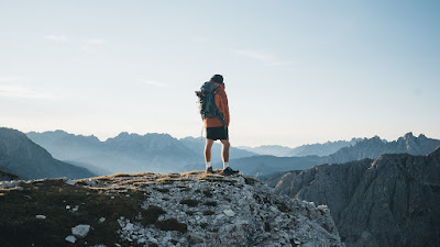 A traveler standing on a mountain top