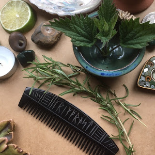 Selection of herbs next to a dark brown Viking comb