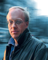 Writer and intellectual Chris Hedges facing the camera with blurry background