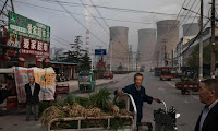  Vendors near a state-owned coal-fired power plant in China. (Photograph Credit: Kevin Frayer/Getty Images) Click to Enlarge.