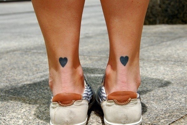 Black heart tattoos on each Achilles heel