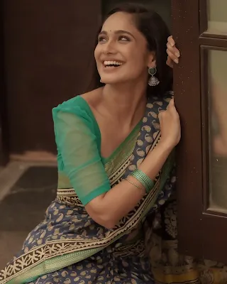 Tejaswini Gowda wearing a traditional saree, looking graceful and elegant in a sophisticated pose