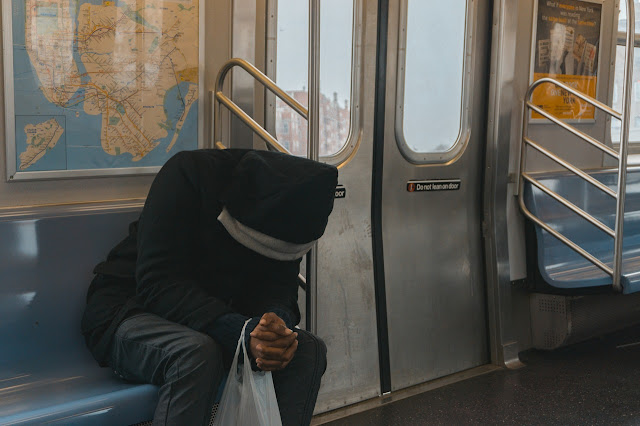 Man with his head lowered on train, stuck in a rut