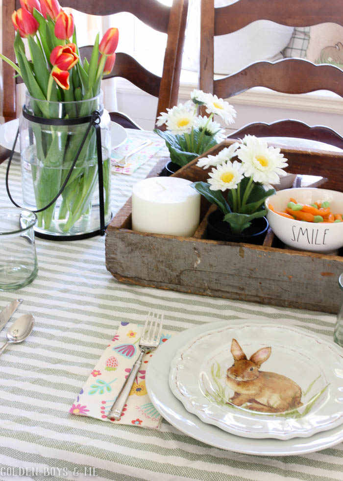 Spring table setting with striped throw used as tablecloth