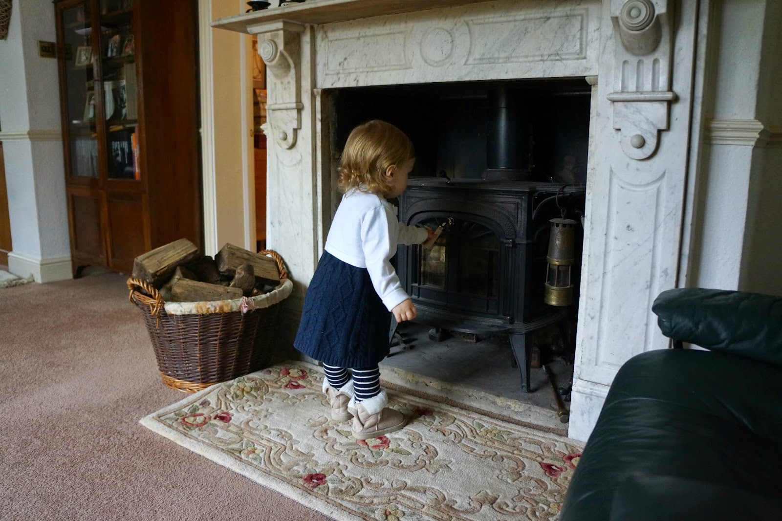 toddler looking at a fireplace