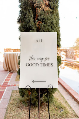 white acrylic wedding sign with black letters on easel