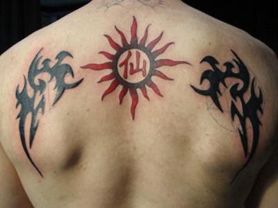 tribal wings and sun tattoo