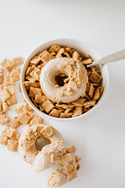 Glazed Cinnamon Toast Crunch Donut sitting on top of a bowl of cereal.
