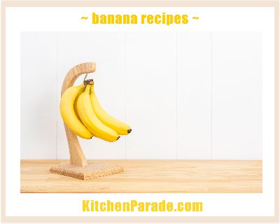 A bunch of yellow bananas hanging on a banana stand linked to recipes calling for bananas ♥ KitchenParade.com.