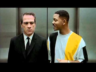 Agent K and James Edwards III, soon to become Agent J, in an elevator. Scene from movie: Men in Black