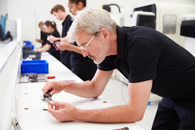 Engineering technician inspecting precision part