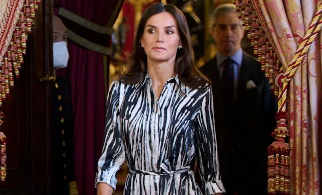 Queen Letizia wore a Danimala zebra-print belted midi shirt dress by Hugo Boss. Carolina Herrera red pumps