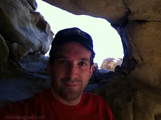 David August in the rock house with the rock house window in the background