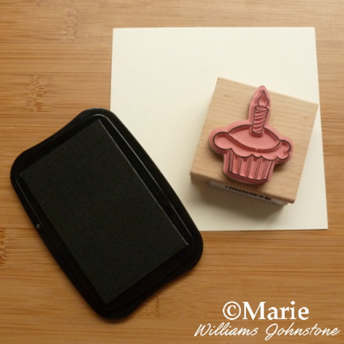 Inking a cupcake birthday stamp with black