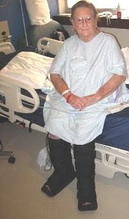 Photo of Lucille Carlson sitting on edge of bed.