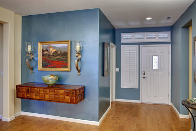 blue and white is like the canvass for artistic details in this entryway