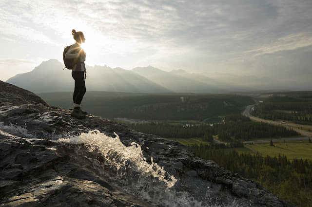 a girl standing on a mountain