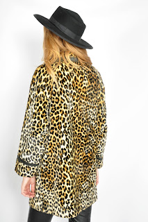 Vintage 1960's leopard print faux fur coat with black leather trim and black button closure.
