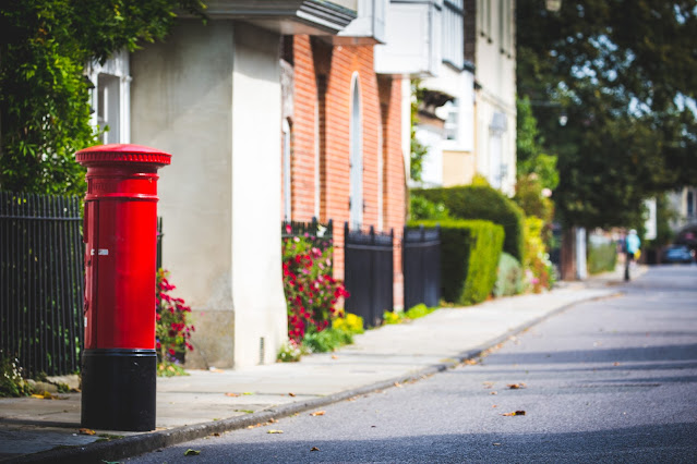 English red postbox on rural street:Photo by Ben Wicks on Unsplash