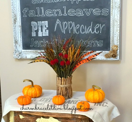 Fall foyer Dollar Tree faux flowers and feathers with fallart chalkboard