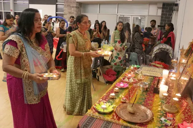 Rashmika Patel and Radha ben Patel perform the “arti” traditional worship rituals as the local Indian community celebrated Diwali recently at Rotary Place.