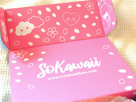 A photo showing a cute pink box interior with cherry blossom flowers, clouds and cat 